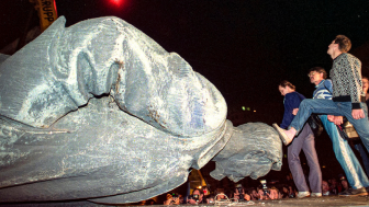 In this Friday, August 23, 1991 file photo, people kick the head of the statue of Felix Dzerzhinsky, the founder of the Soviet secret police, in front of the KGB main headquarters on Lubyanka Square in Moscow, Russia. The statue was pulled down after the defeat of the August 1991 hardline coup. This was a watershed moment that symbolized the collapse of the repressive Soviet system.